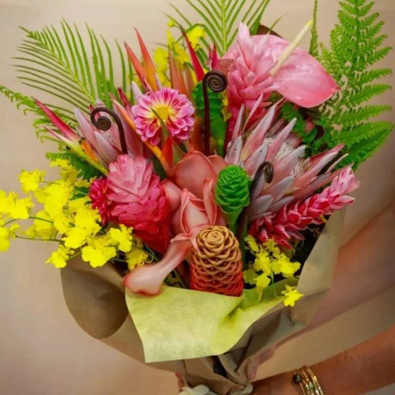 A person holding a bouquet of flowers in their hand.