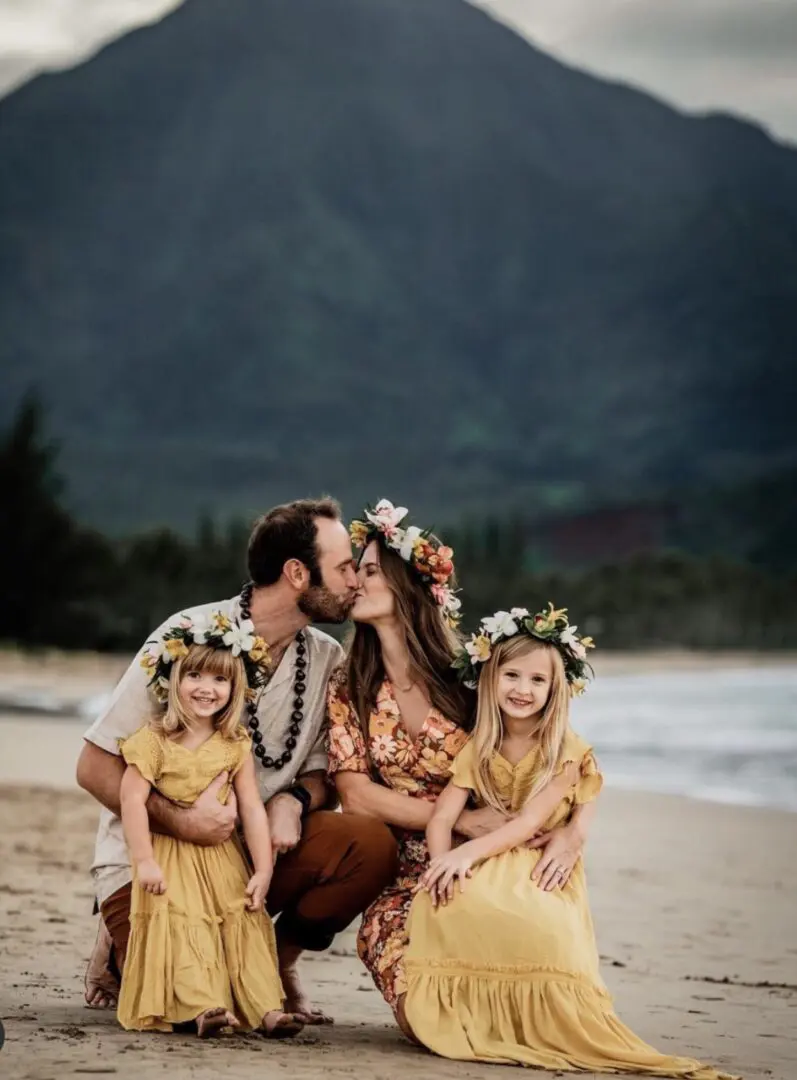 A man and two girls on the beach